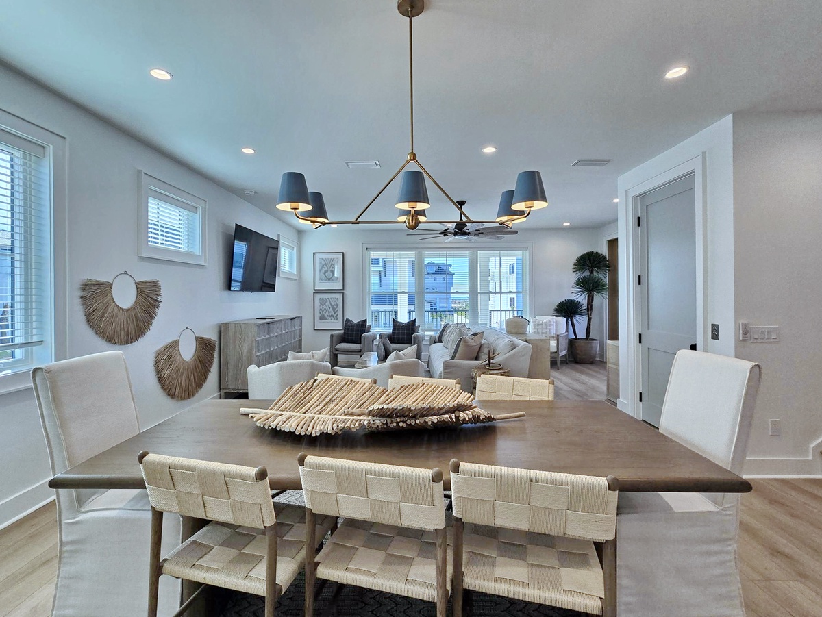 You'll love gathering around this elegant dining table while the open-concept living room beckons with stylish seating.
