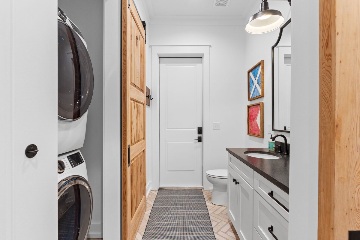 Your private laundry room features a full-size washer and dryer alongside a convenient half-bath for ultimate comfort.