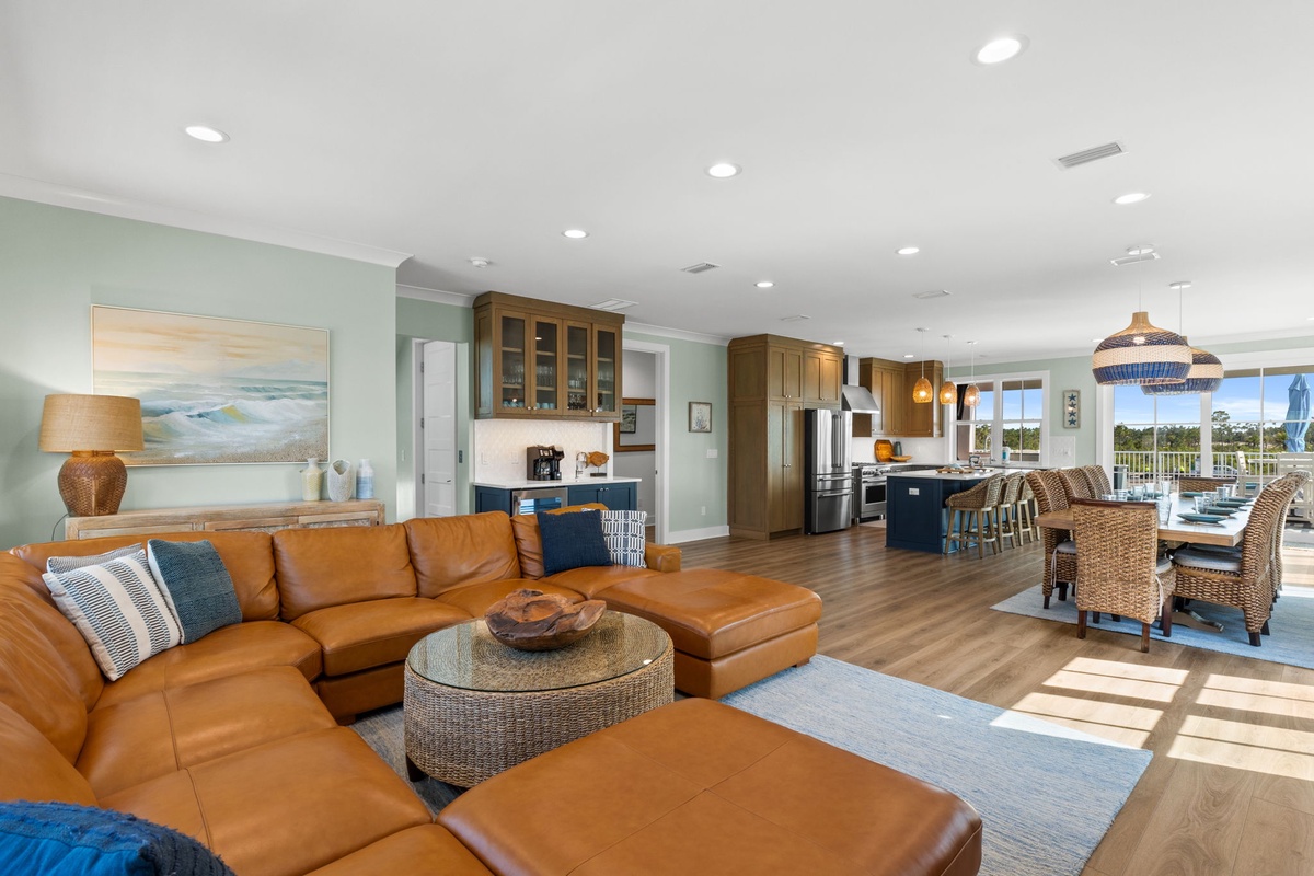 You'll love relaxing in this bright, open living space where natural light streams through large windows while you unwind on the comfortable leather sectional or gather with family around the fully equipped kitchen's island.