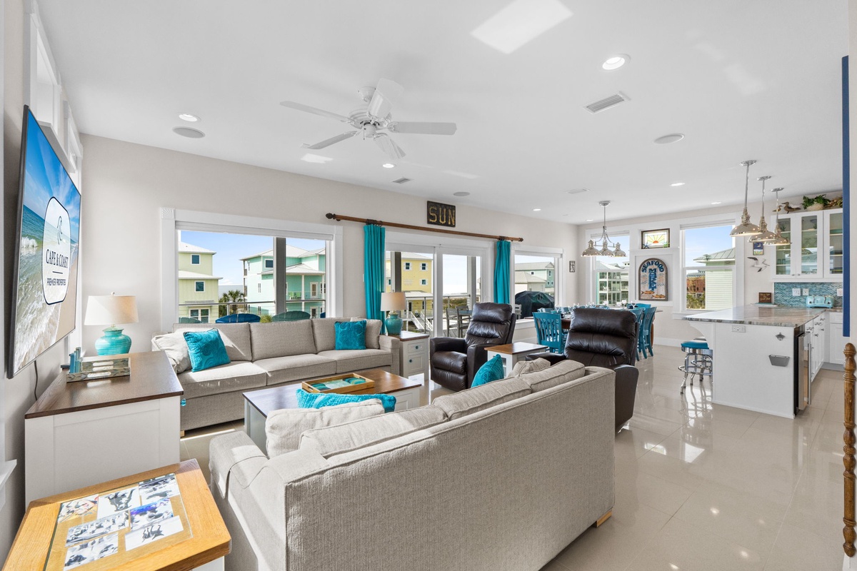Relax in your bright, modern living space with stylish furnishings and turquoise accents that capture the coastal vibe perfectly.