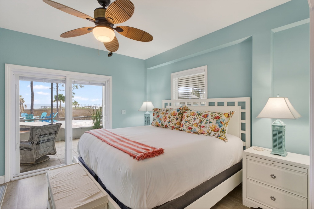 Drift off to sleep in your coastal retreat with soft aqua walls and tropical touches, while ocean breezes flow through your private balcony.