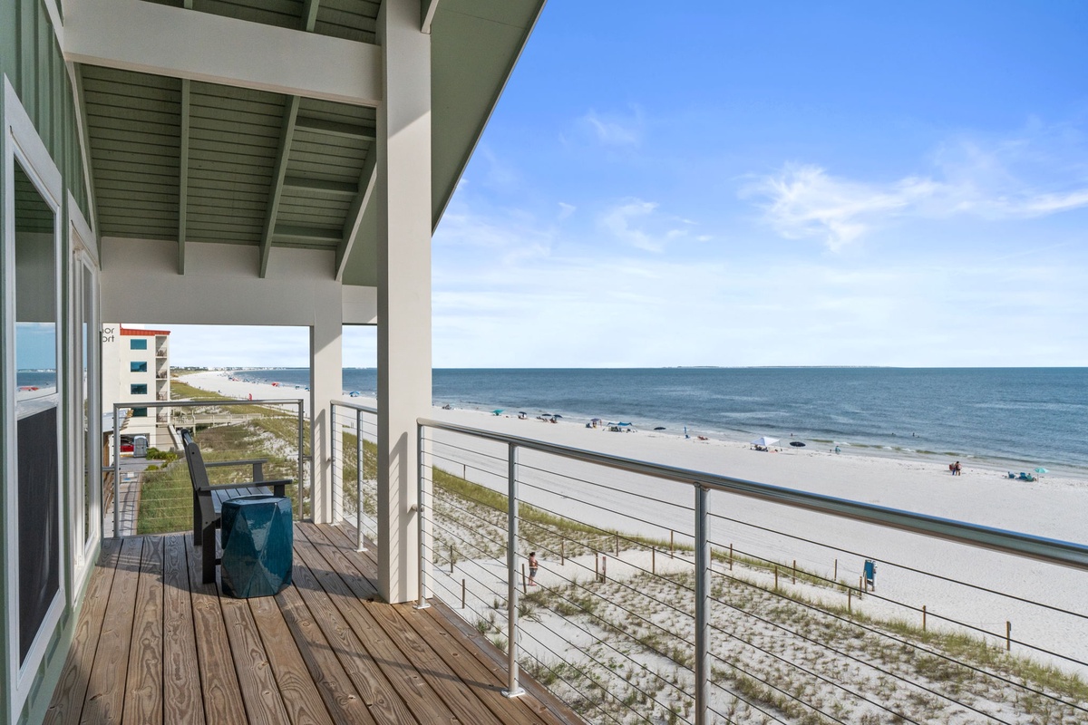 Panoramic beachfront balcony features sweeping coastal views, perfect for morning coffee or sunset cocktails by the shore.