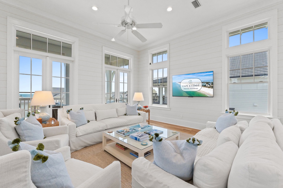 Sink into plush sofas in your bright living room, where ocean breezes drift through tall windows and coastal views frame every moment of relaxation.