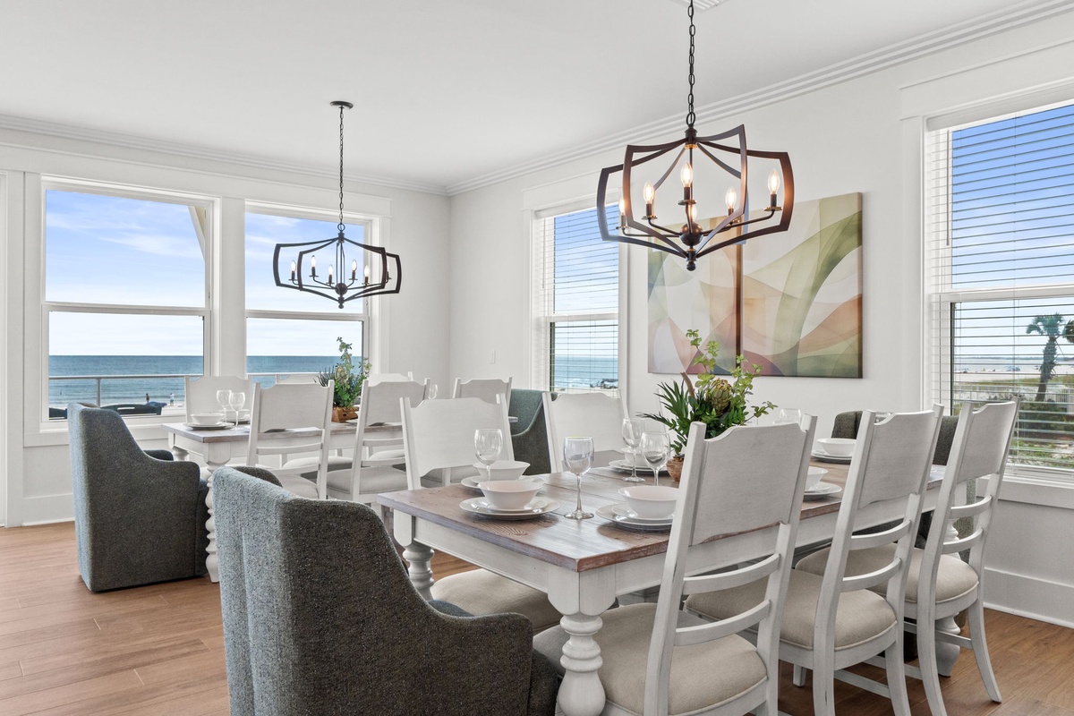 Picture yourself hosting memorable meals with the ocean just beyond the windows—bright coastal light streaming in as you gather around this elegant dining space with stunning sea views.