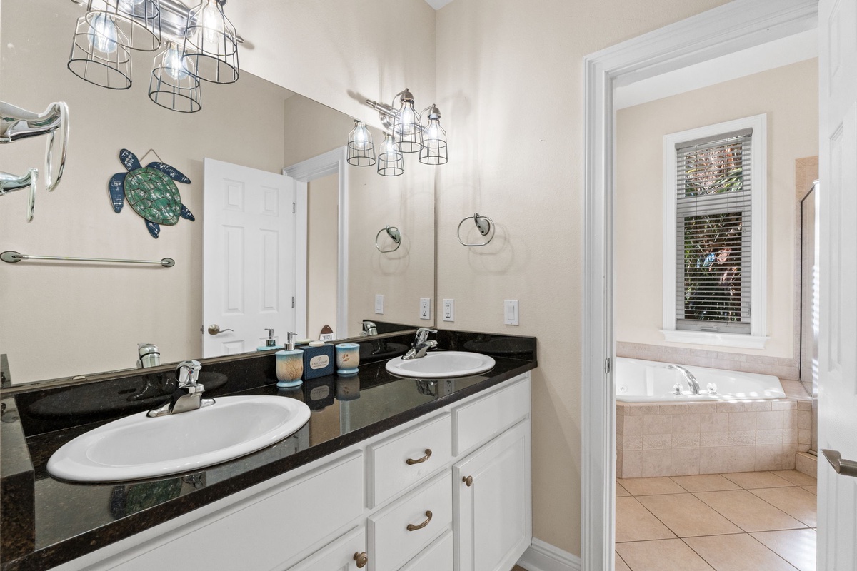 Refresh in your spacious dual-sink bathroom with coastal turtle decor and modern fixtures, perfect for getting ready together.