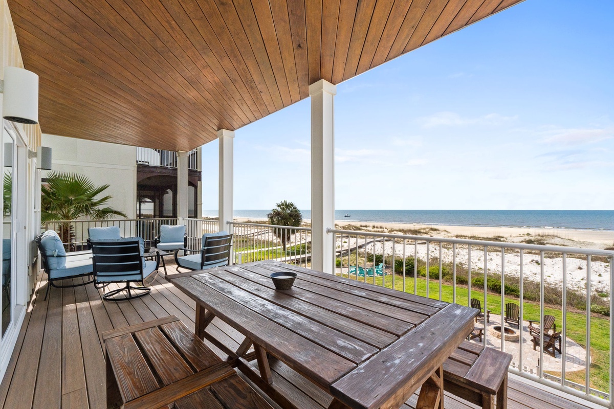 Expansive balcony features comfortable seating and direct ocean views, creating an ideal spot to enjoy coastal breezes and watch the waves roll in throughout your stay.