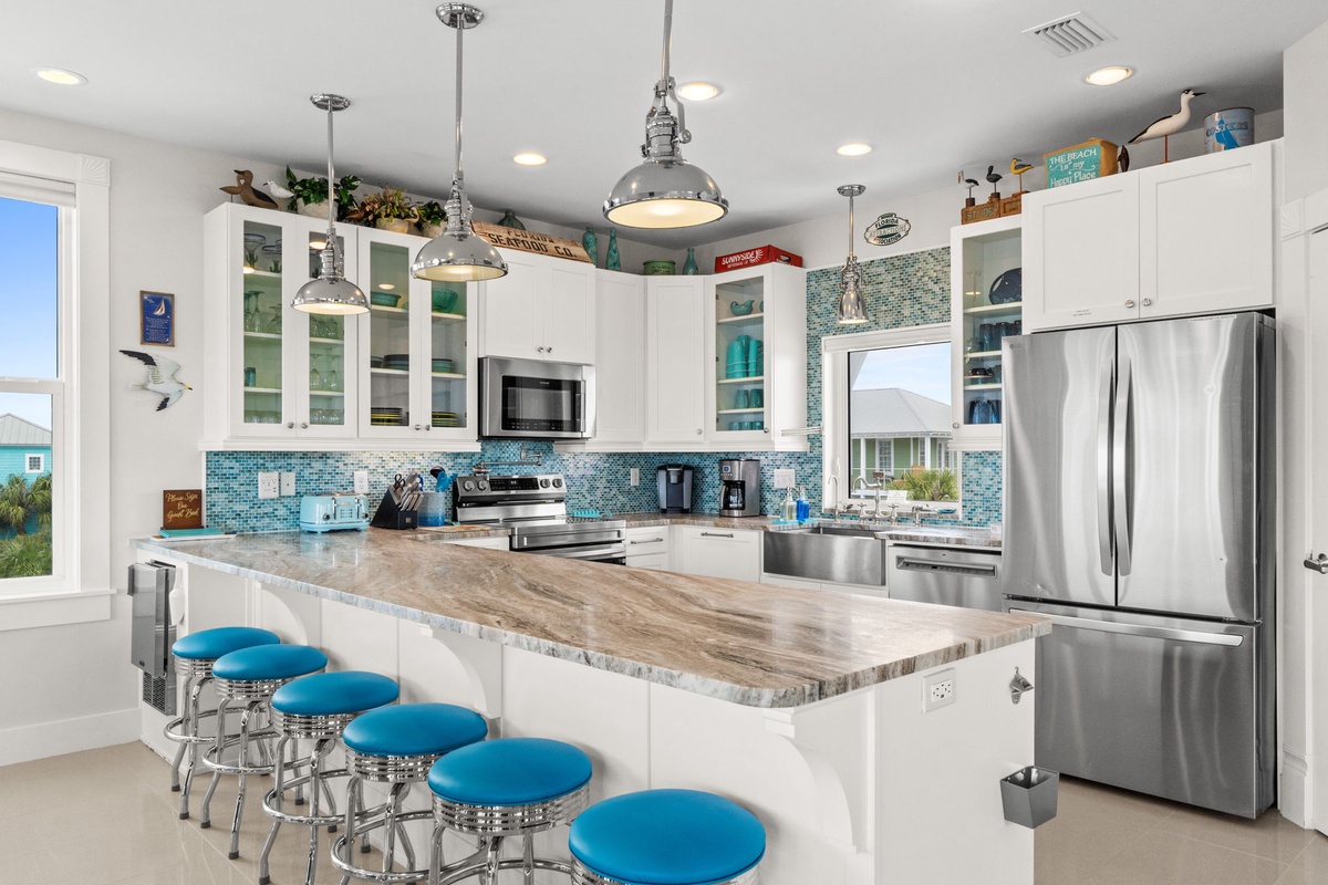 Your stunning coastal kitchen features gleaming stainless steel appliances and a spacious island where you'll create memorable meals together.