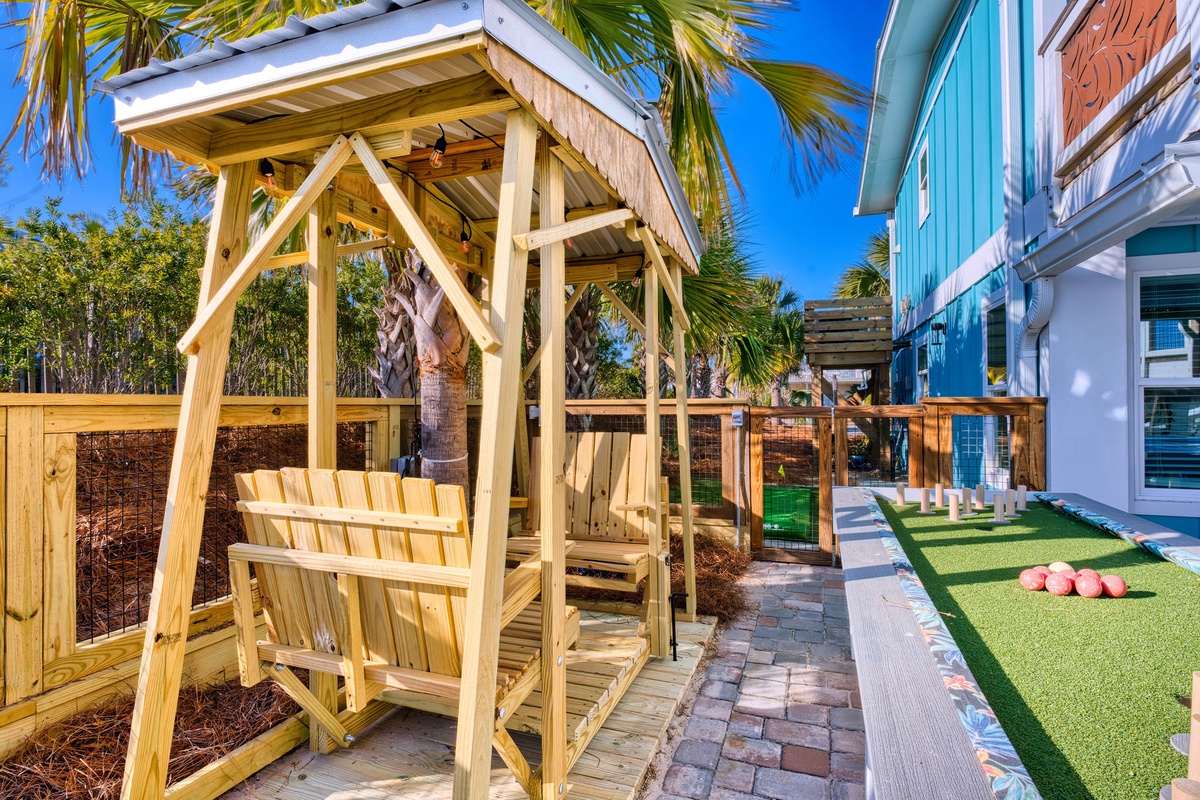 Wooden glider under the palms.