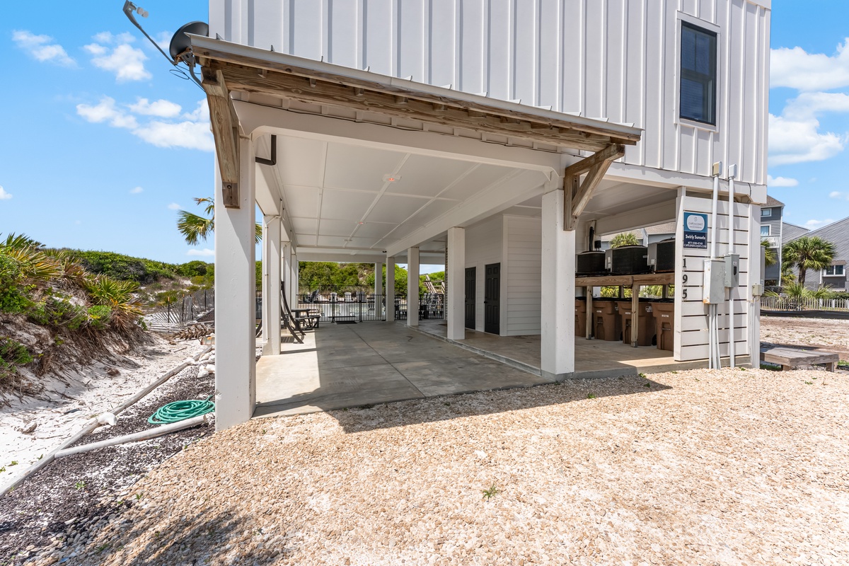 Elevated coastal property featuring covered outdoor area and beach access in a tropical setting.