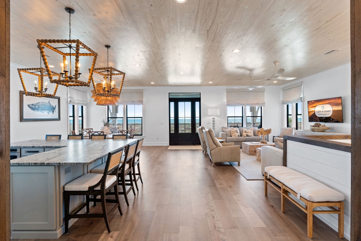 Gather with loved ones in this stunning open-concept space where coastal charm meets modern luxury, complete with ocean views.