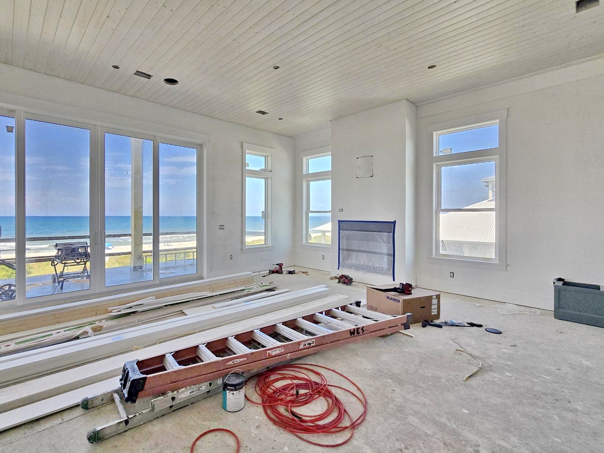 This bright space showcases stunning ocean views through expansive windows, offering a peaceful coastal setting for your getaway.