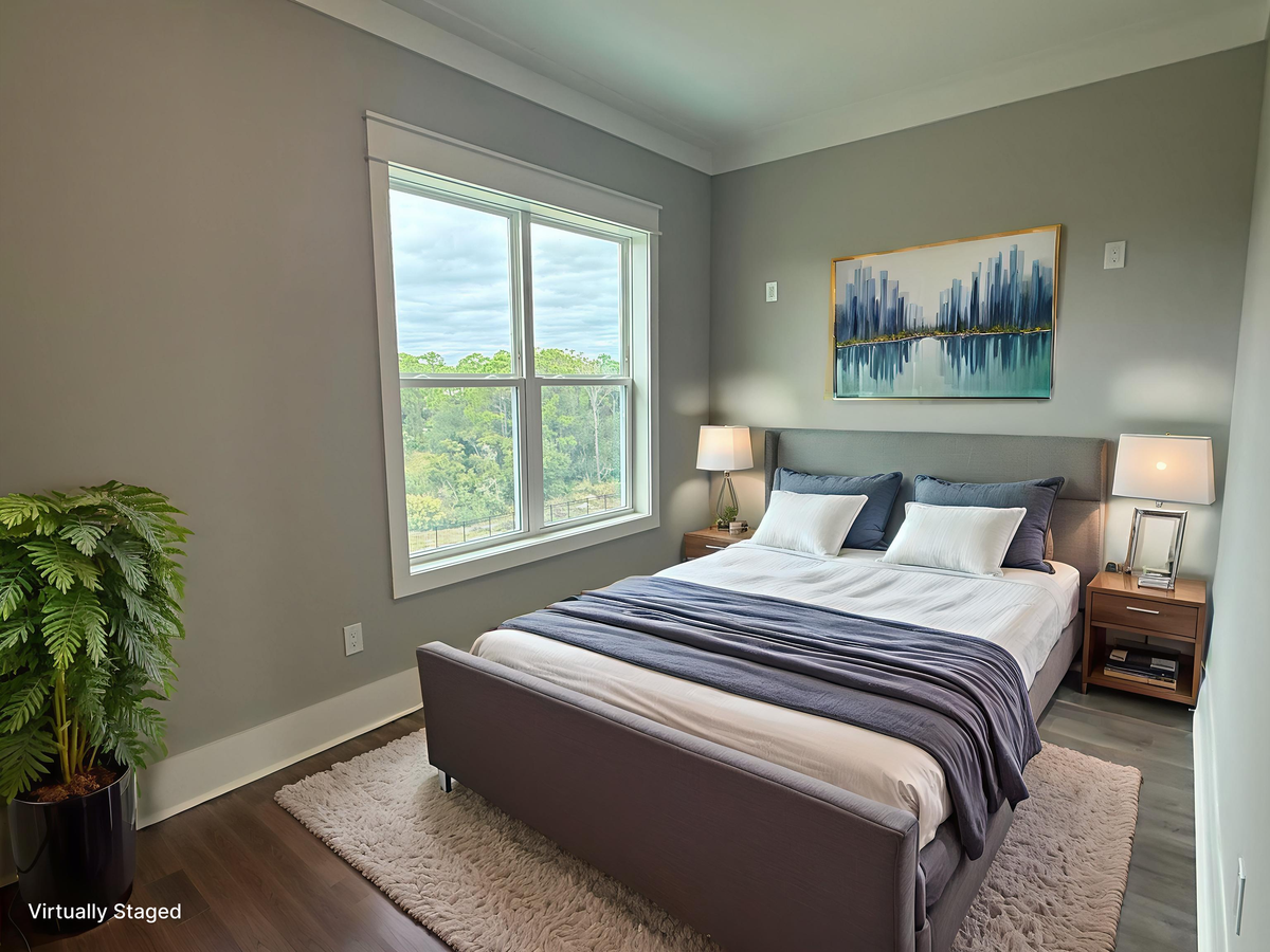 Sink into crisp linens and wake to treetop views in your peaceful bedroom retreat, complete with modern furnishings and calming blue accents.