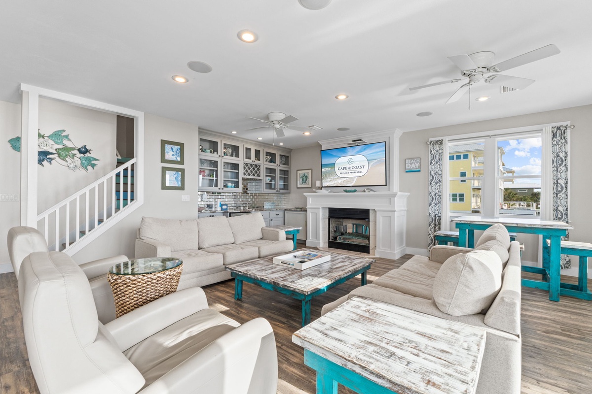 Relax in this bright coastal living space with plush seating, turquoise accents, and charming nautical touches that make you feel at home.