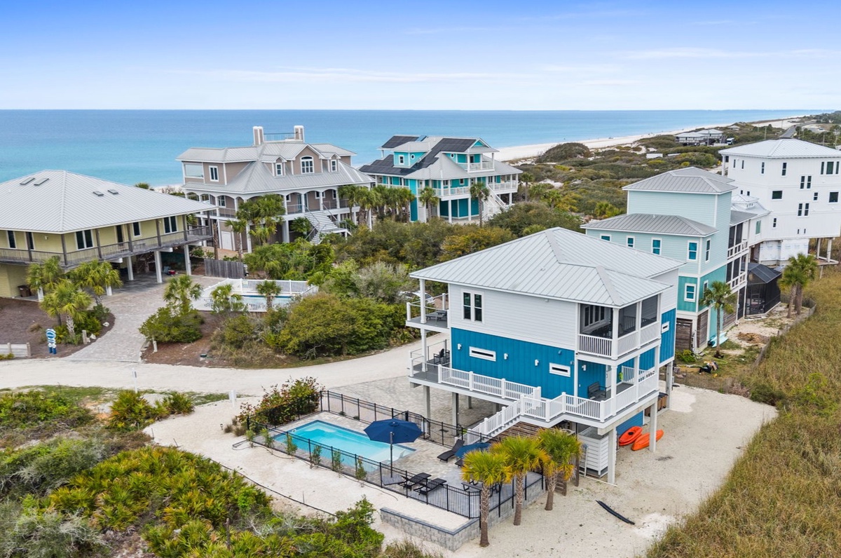 Coastal vacation rental community featuring beachfront homes with private pools and direct beach access.