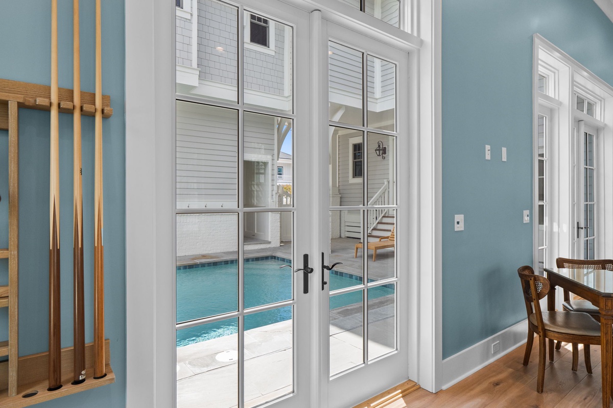 Step through these elegant French doors and discover your private pool oasis waiting just beyond—a refreshing retreat steps from your living space.