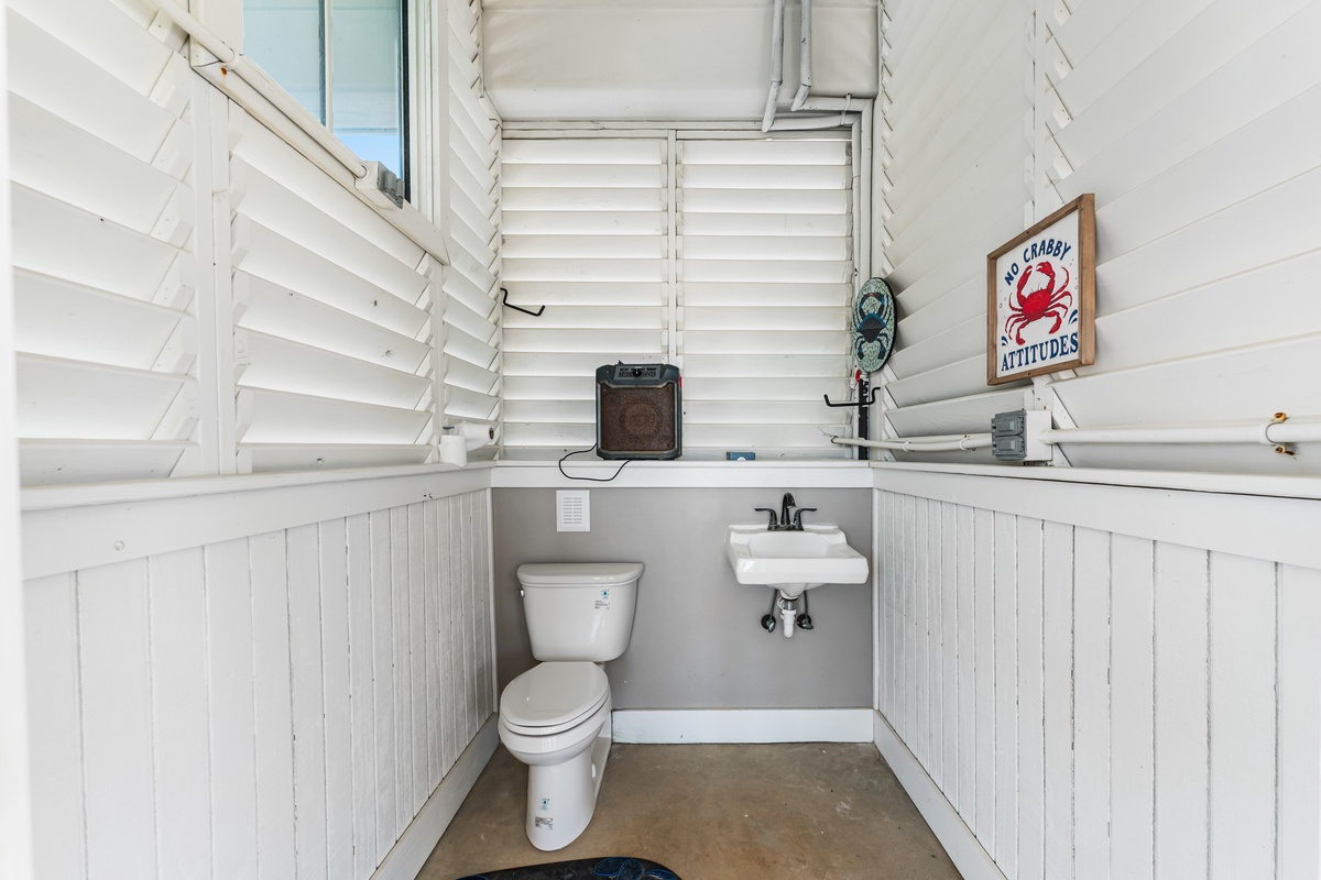 Freshen up in this charming coastal powder room with playful nautical touches and practical amenities for your convenience.