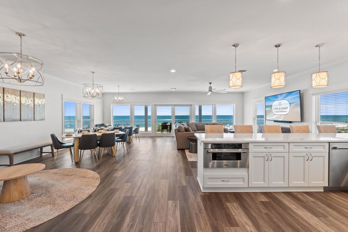 Step into your dream coastal retreat where floor-to-ceiling windows frame breathtaking ocean panoramas. Gather around the spacious dining table or unwind in the open living area, all bathed in natural light and sea breezes.