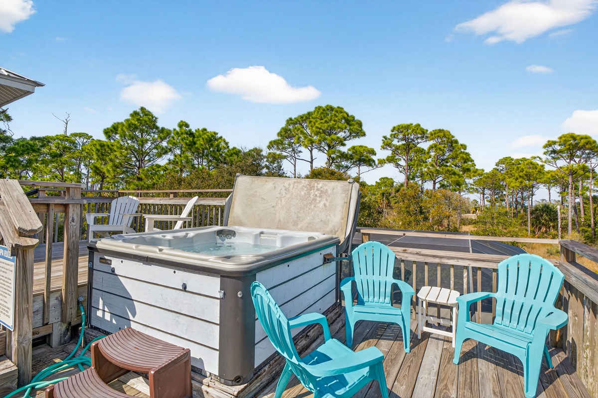 Soak your worries away in your private hot tub while turquoise chairs invite you to relax on this sunny deck.