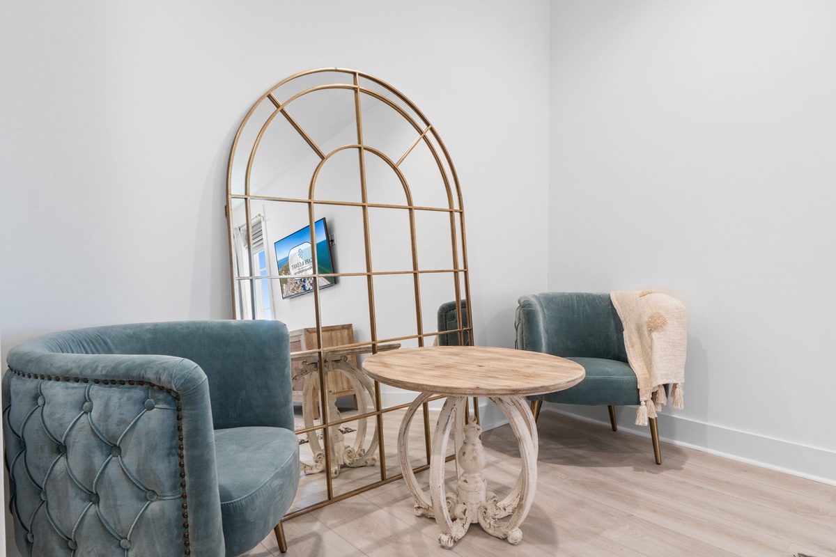 Sink into plush velvet chairs and enjoy intimate conversations in your stylish seating nook with elegant touches.