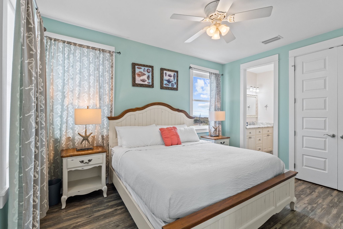 Drift off in this serene coastal bedroom with calming seafoam walls and crisp white linens.