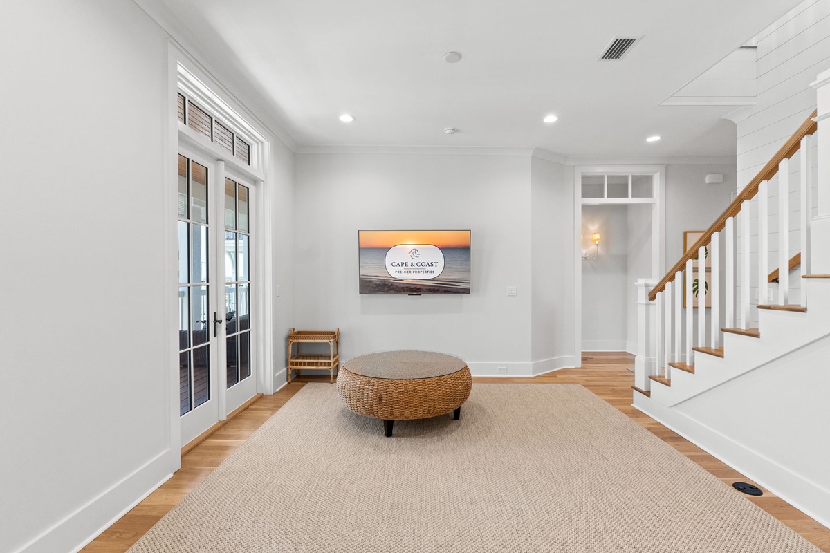 Settle into your serene retreat space with warm wood floors, coastal vibes on the screen, and plenty of natural light—your perfect spot to relax and unwind.