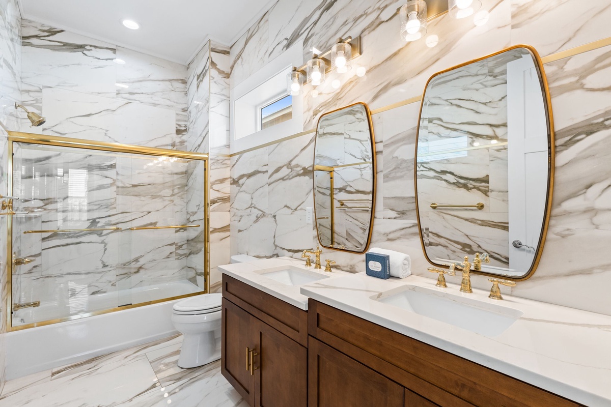 Luxurious marble bathroom with elegant gold fixtures and double vanity for your spa-like retreat.