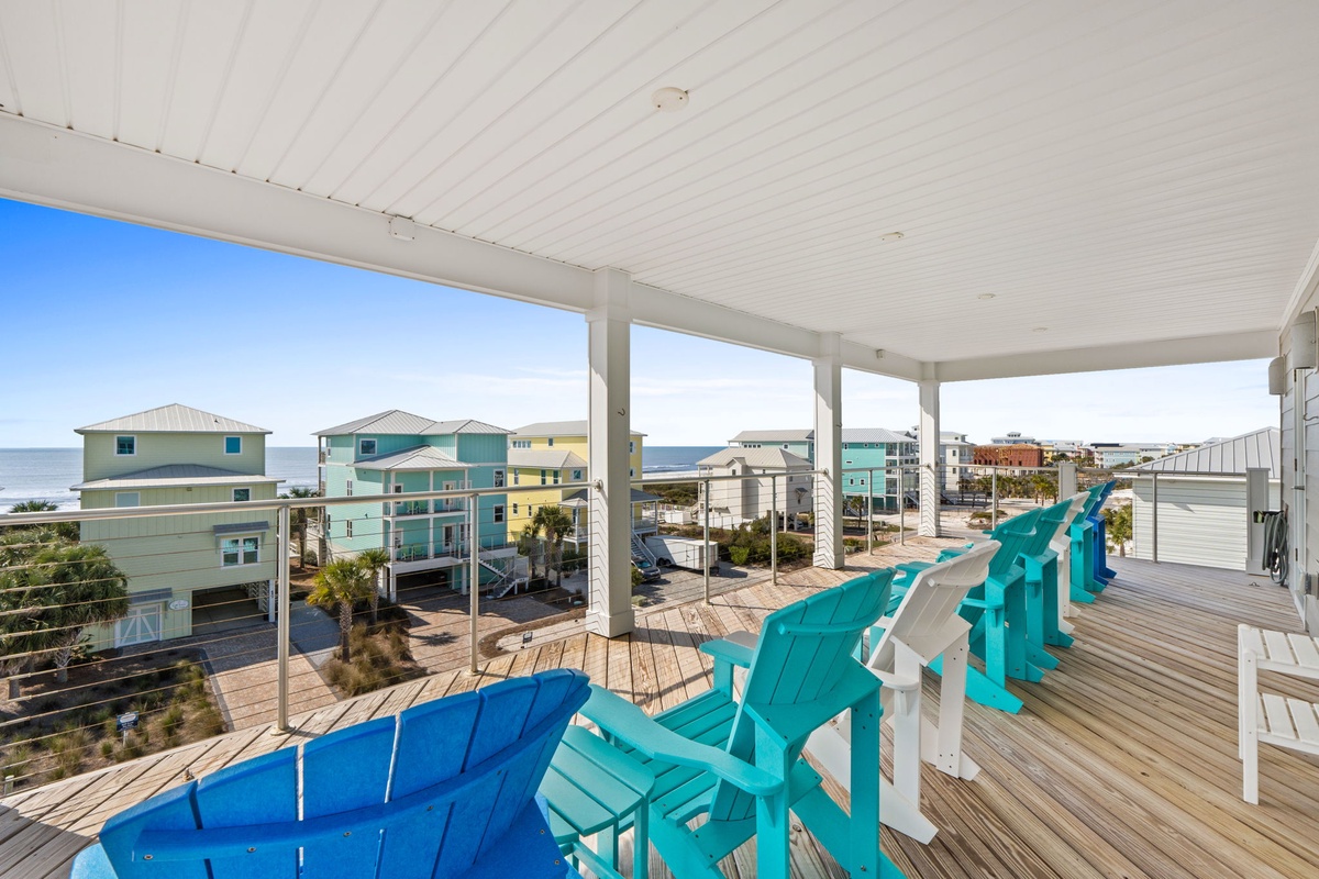 Relax in colorful Adirondack chairs on your covered deck with stunning ocean and neighborhood views.