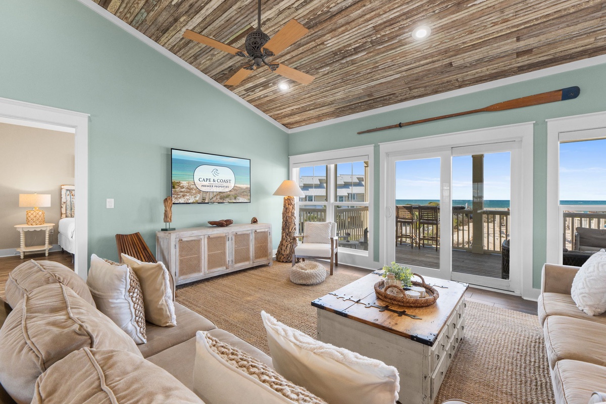Sink into plush coastal comfort in your oceanfront living room, where warm sea breezes flow through French doors onto your private deck.