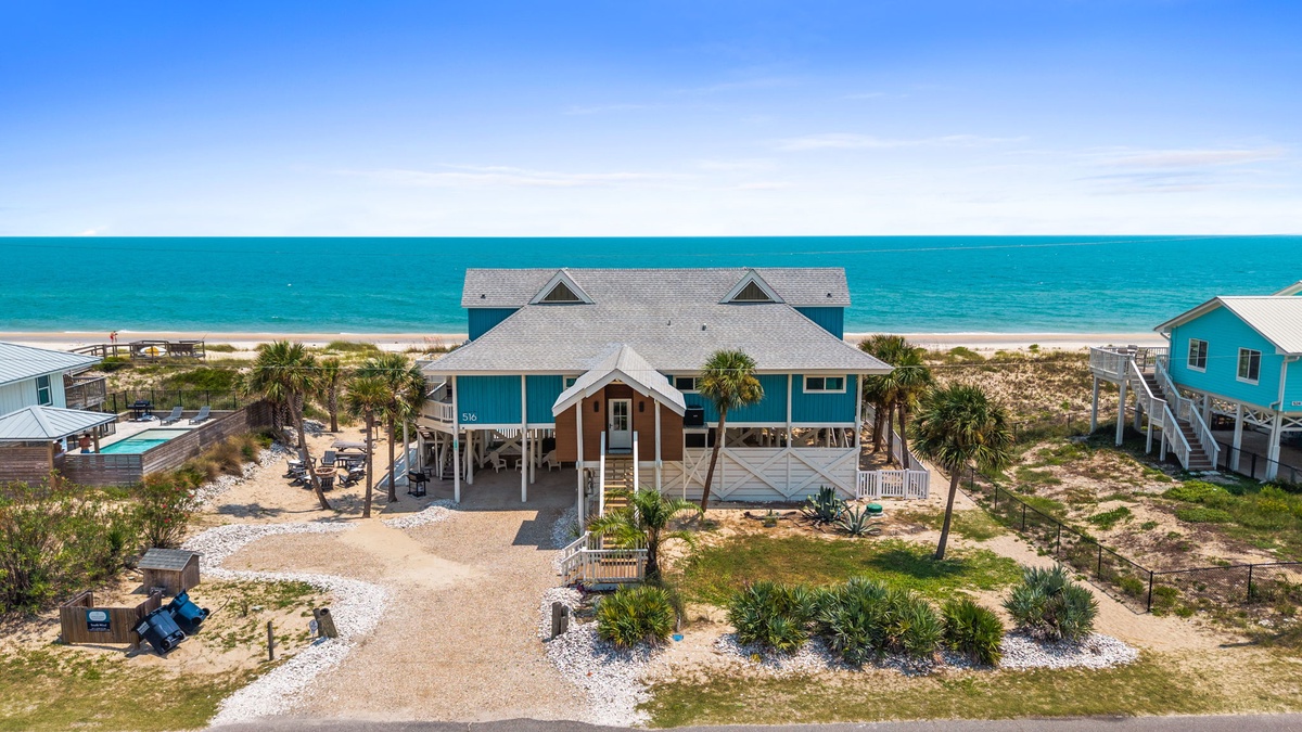 This Gulf Coast retreat offers direct beach access and stunning beachfront positioning, with palm-studded grounds and neighboring coastal homes completing the idyllic island setting.
