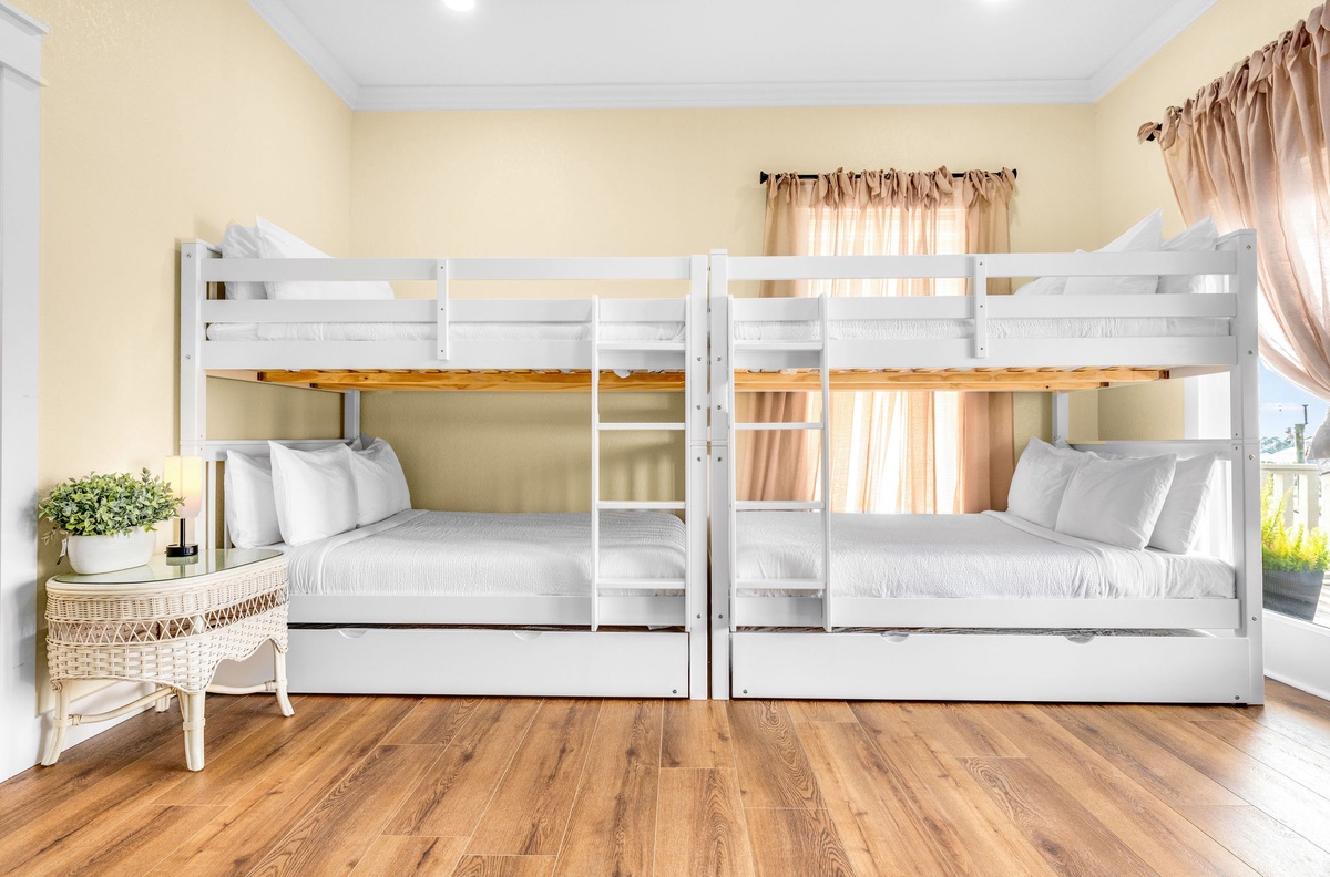 Rest in your cozy bunk room with crisp linens and warm natural light streaming through soft curtains.