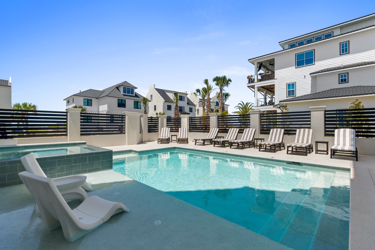 Modern beachside resort with a sparkling pool, sundeck loungers, and palm-lined courtyards—your private slice of coastal paradise.