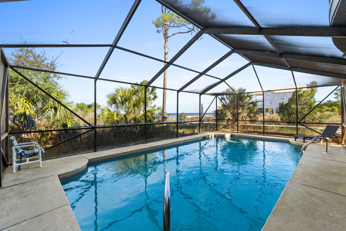 Dive into your private enclosed pool surrounded by tropical palms and lush greenery—perfect for swimming any time of year.