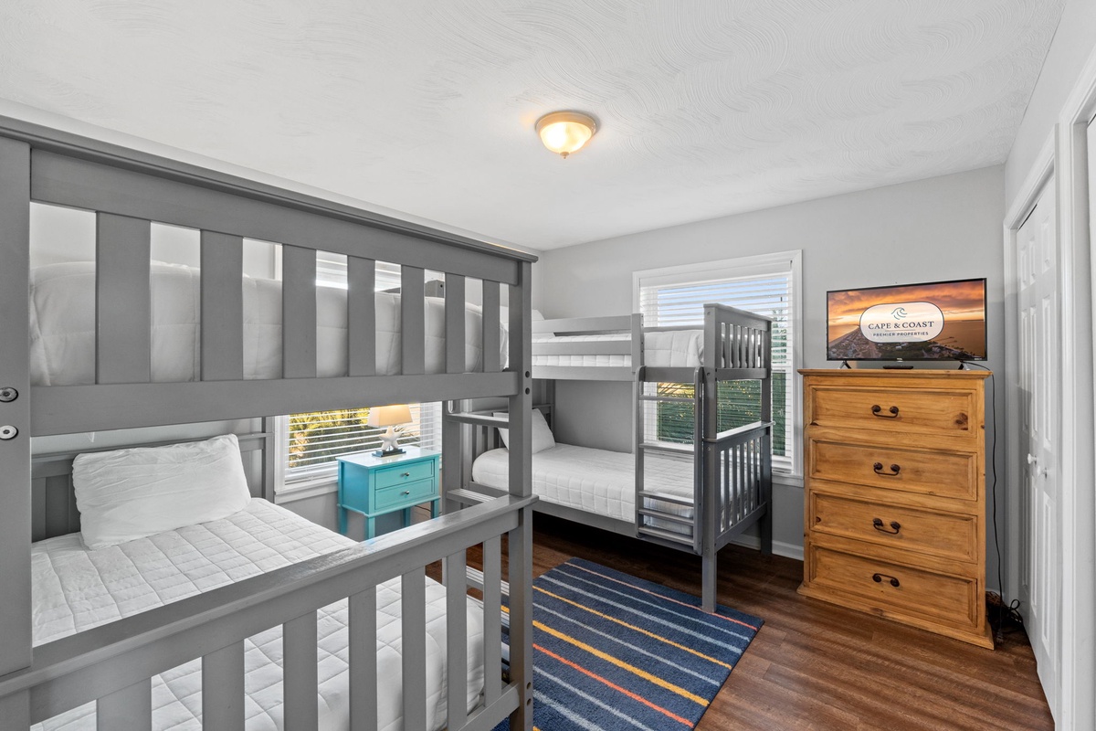 Your kids will love this cozy bunk room with sturdy gray beds and plenty of space to play and relax together.