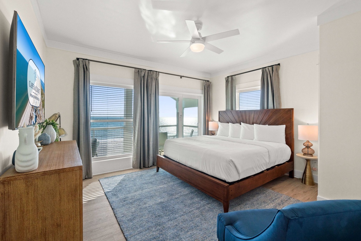 Drift off to sleep in this serene bedroom with crisp linens and gentle ocean breezes from your private balcony.