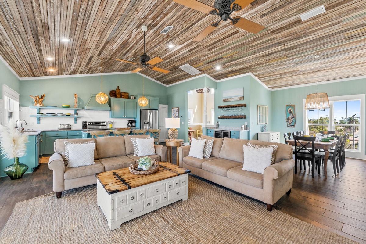 Unwind in your spacious open-concept living space with stunning reclaimed wood ceilings and coastal-inspired decor that makes every moment feel like vacation.