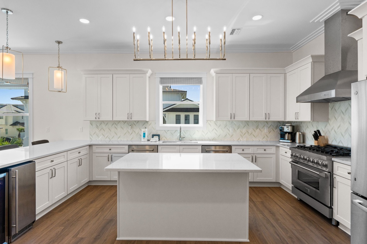 A bright, spacious kitchen with elegant fixtures and a large center island where you can prepare meals together or gather with friends over morning coffee.