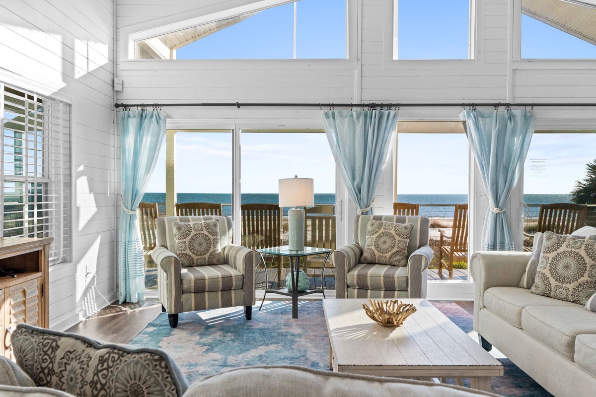 Sink into plush seating while ocean breezes drift through your private retreat, where coastal elegance meets barefoot comfort.