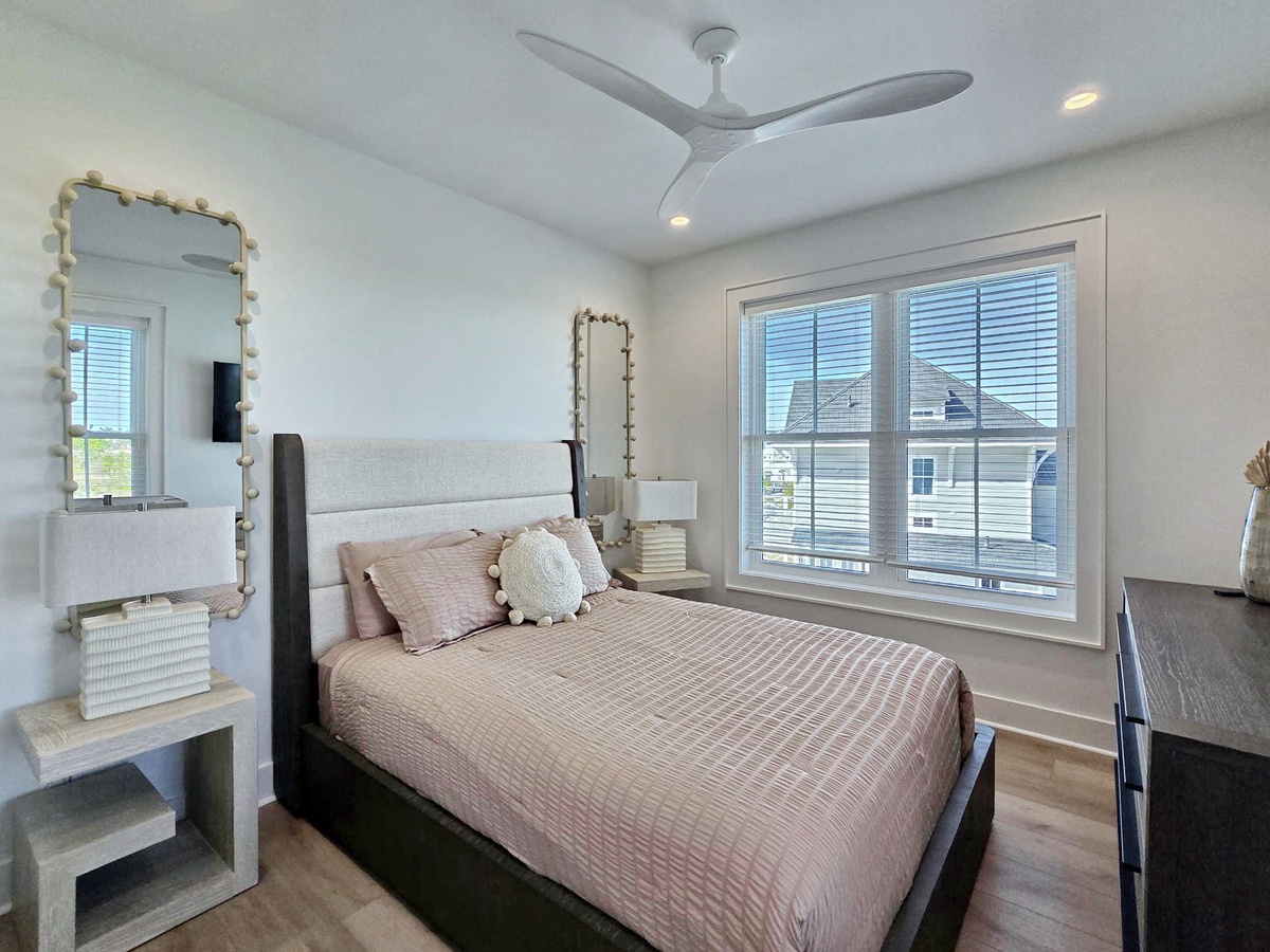 Step into your serene bedroom sanctuary with comfortable bedding, natural light streaming through large windows, and modern touches throughout.