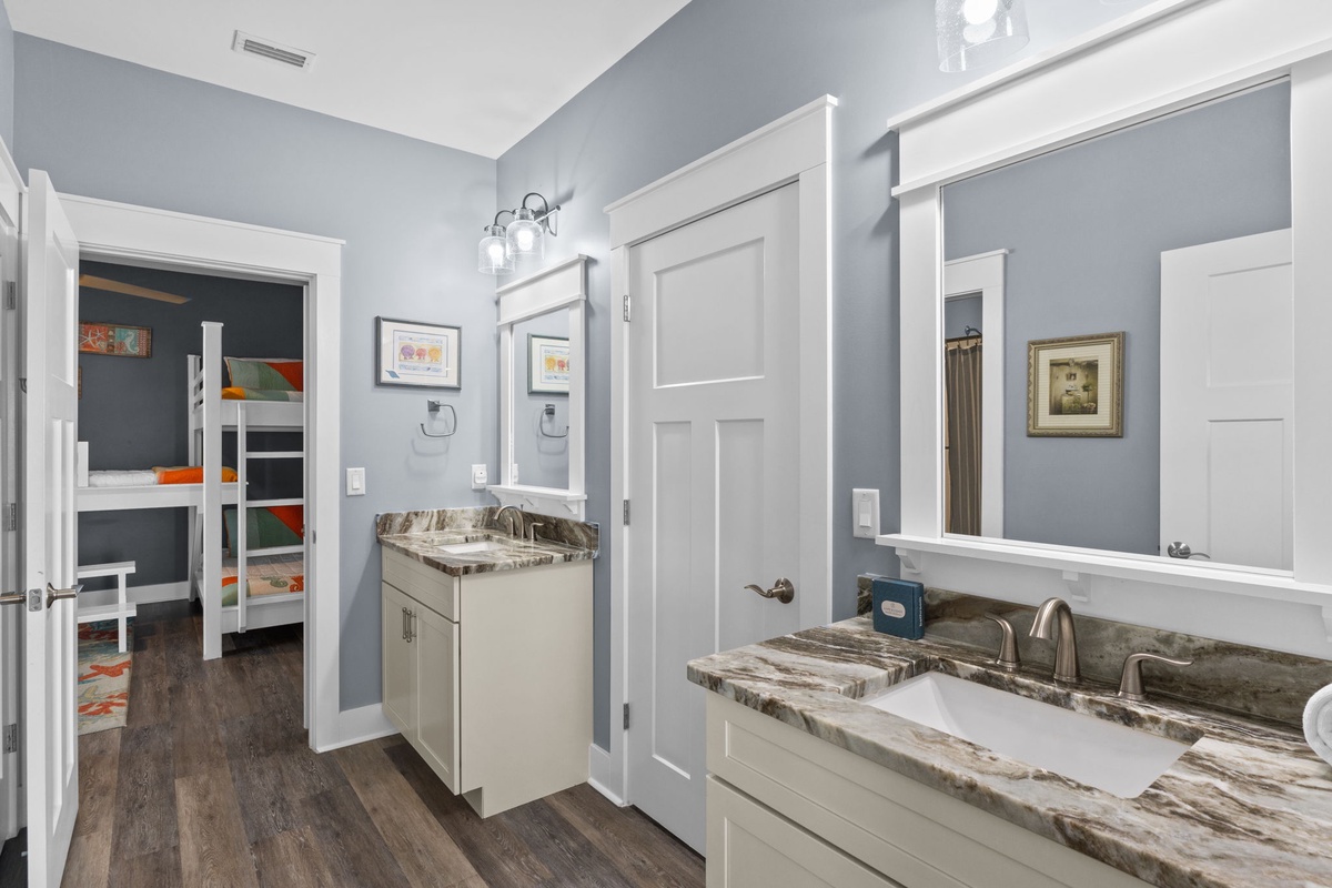 Your shared bathroom features dual vanities and marble countertops, creating a spa-like morning routine for your group.