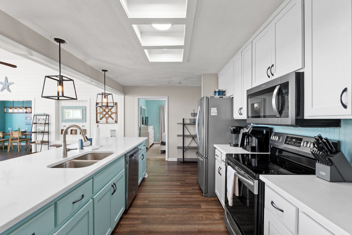 You'll love cooking in this bright, spacious kitchen with modern appliances, stylish pendant lighting, and cheerful coastal colors.