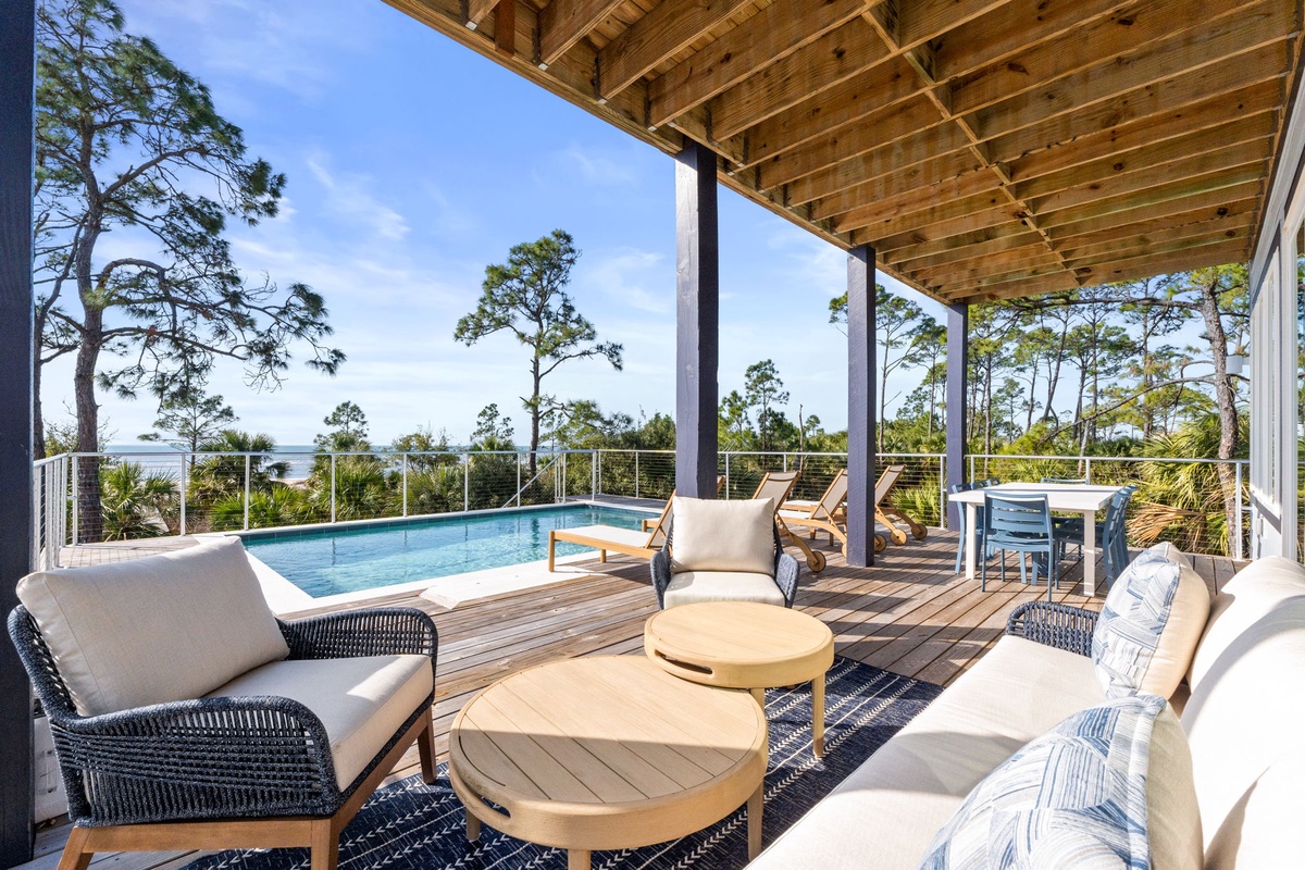 Relax in your private poolside paradise with stunning water views and coastal breezes through towering pines.
