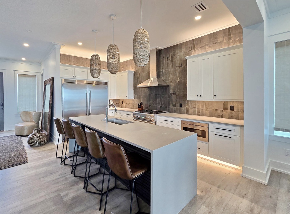 Gather around this stunning kitchen island where modern luxury meets warm comfort—perfect for morning coffee or evening conversations.
