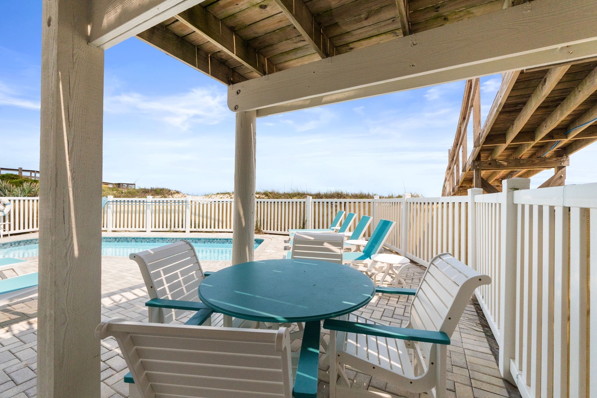 Relax under your private pergola with direct pool and beach views—your coastal retreat includes shaded dining steps from sun-soaked loungers and gentle ocean breezes.