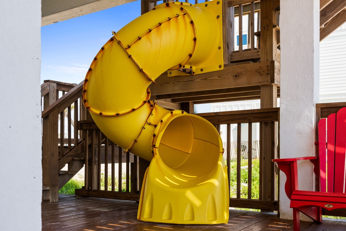 A bright yellow spiral slide offers endless fun right on the property—perfect for families with adventurous kids looking to make unforgettable vacation memories.