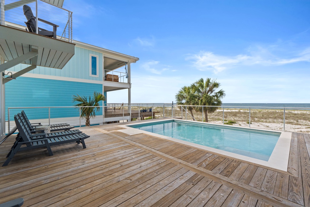 A bright beachfront retreat with private pool, rooftop deck, and stunning ocean views steps from pristine white sand dunes and swaying palms.
