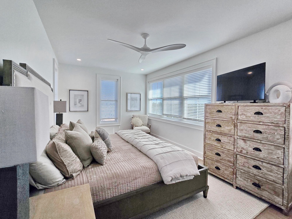 Sink into comfort in your serene bedroom with plush bedding, rustic charm, and peaceful natural light streaming through.