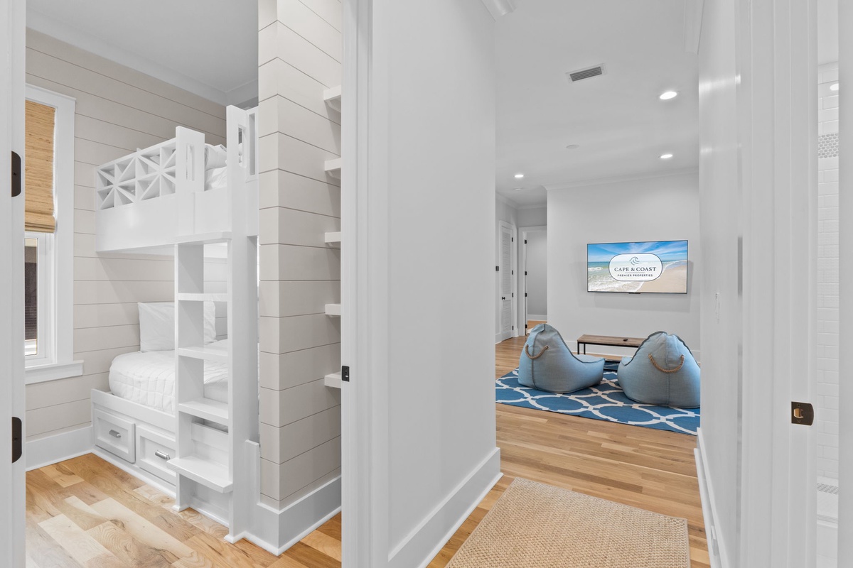 Bright coastal retreat with custom bunk beds and a cozy lounge where your family can unwind after sun-soaked beach days in complete comfort.
