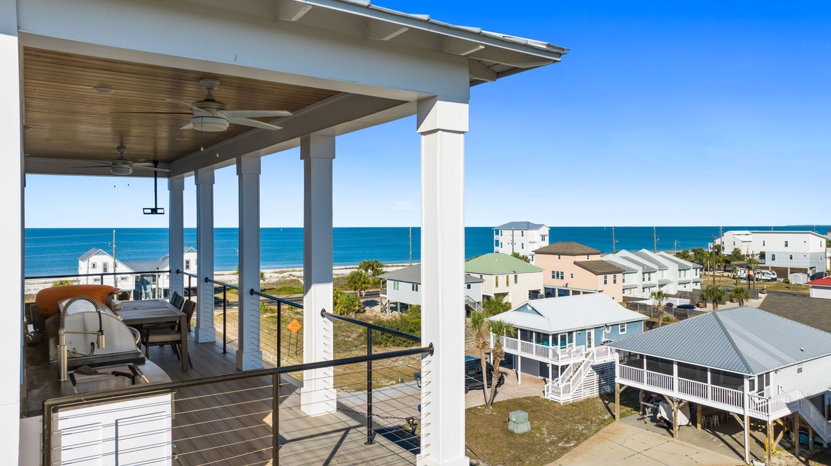 Stunning ocean views from your private covered balcony with outdoor grilling station and ceiling fans for ultimate comfort.