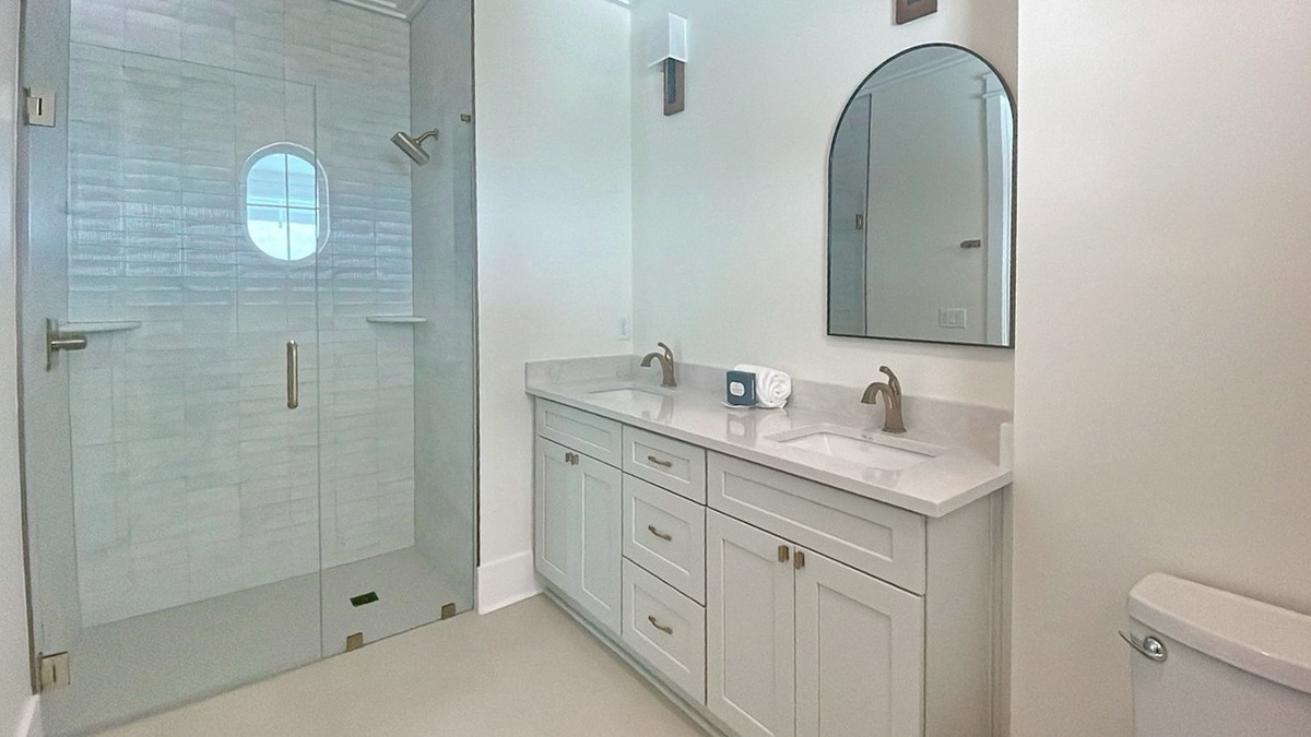 Freshen up in your beautifully appointed bathroom with a spacious walk-in shower, dual vanity, and elegant finishes that blend modern style with comfort.