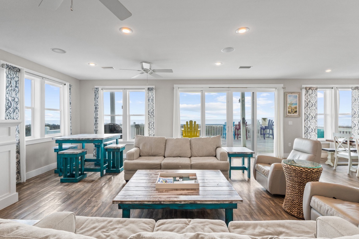 Sink into plush sofas while ocean breezes flow through sliding doors to your private deck with colorful beach chairs.